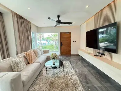Modern living room with sleek design, large TV, and stylish furniture