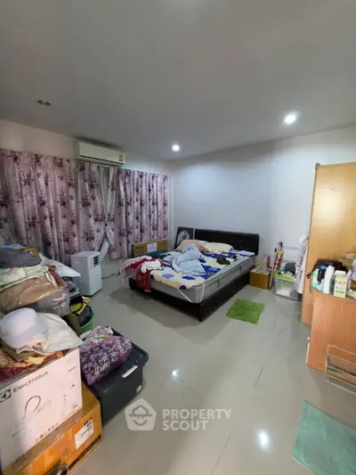 Spacious bedroom with modern air conditioning and ample storage space, ideal for comfortable living.