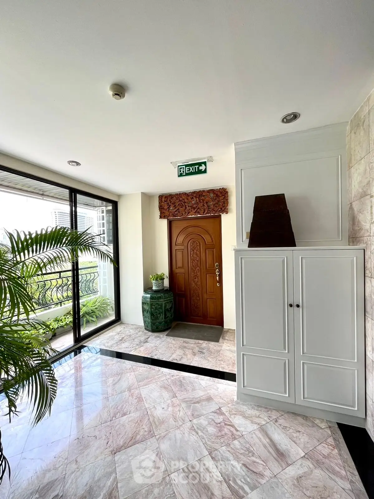 Elegant apartment entrance with marble flooring and stylish decor