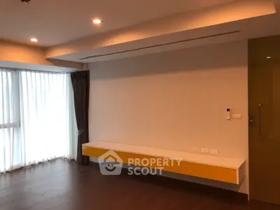 Spacious modern living room with large window and stylish wooden flooring