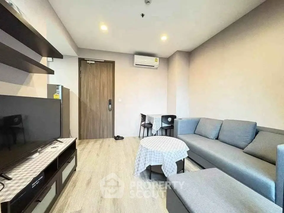 Modern living room with sleek furniture and air conditioning in a cozy apartment.