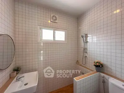 Modern bathroom with white tiles and minimalist design