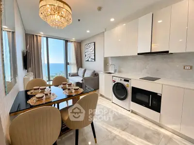 Luxurious open-plan kitchen and living room with ocean view, modern appliances, and elegant dining area.