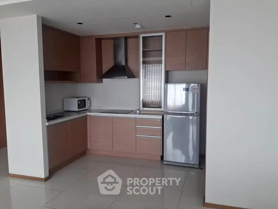 Modern kitchen with sleek cabinetry and stainless steel appliances in a contemporary apartment.