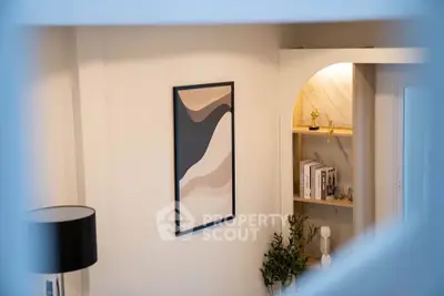 Stylish modern interior with abstract art and elegant shelving in a cozy living space.