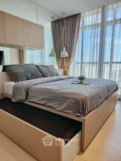 Modern bedroom with large windows and stylish decor in a high-rise apartment.