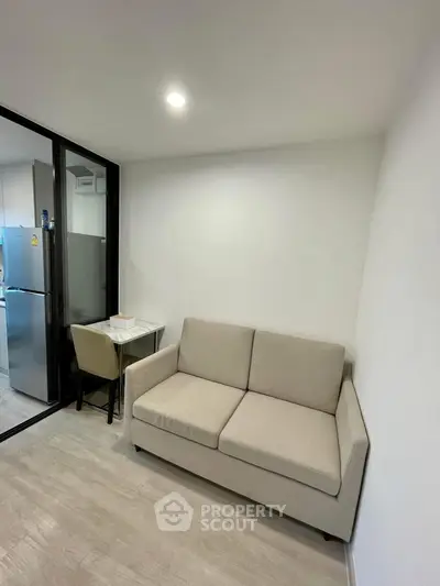 Cozy modern living room with beige sofa and compact dining area