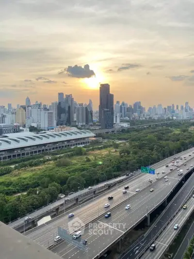 Stunning cityscape view with lush greenery and modern skyline at sunset.