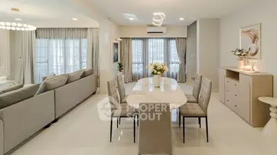 Elegant open-plan living and dining area with modern decor and ample natural light.