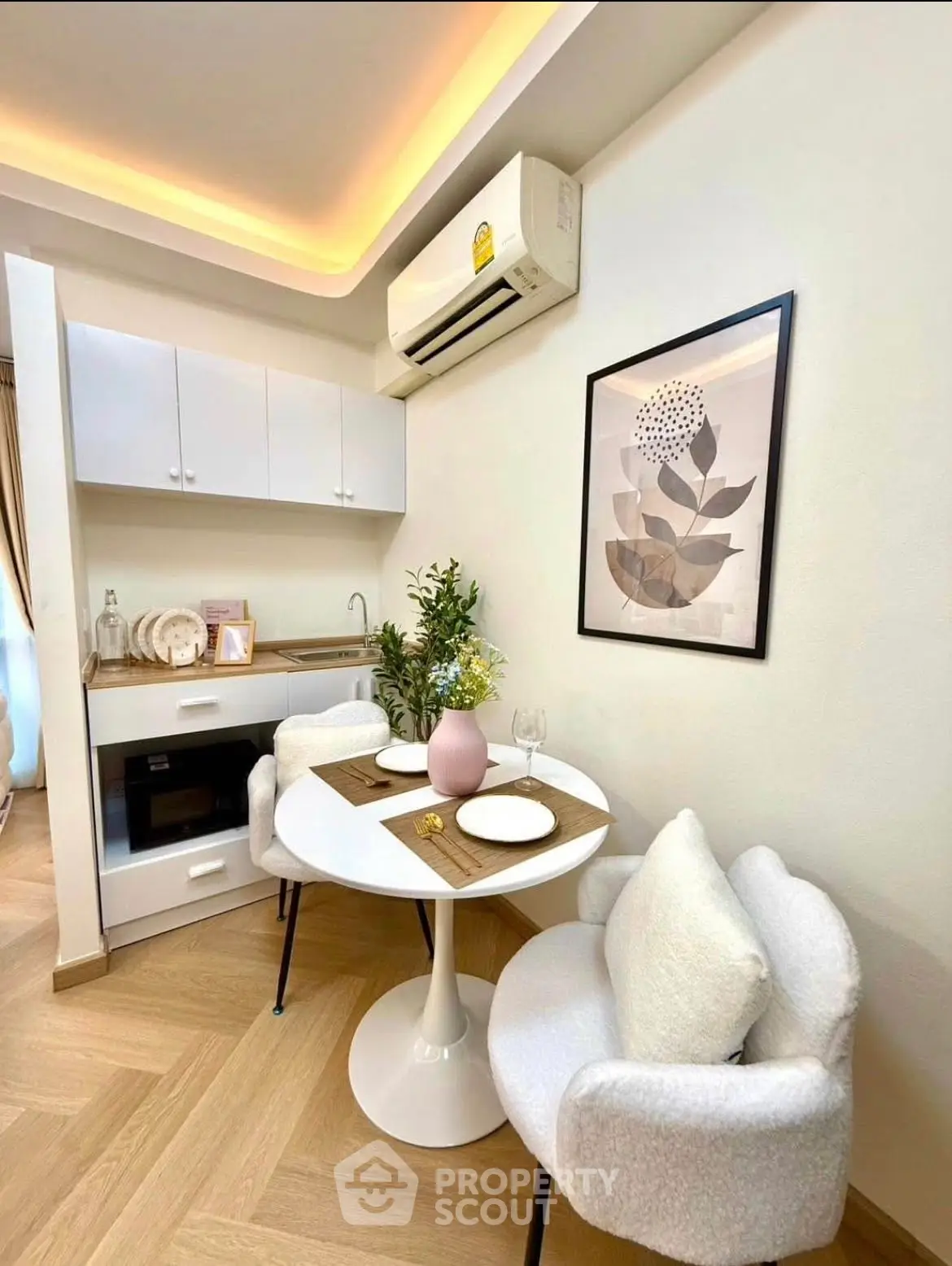 Cozy modern kitchen with dining area, featuring stylish decor and compact appliances.