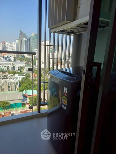 High-rise balcony with city view and washing machine, perfect for urban living.