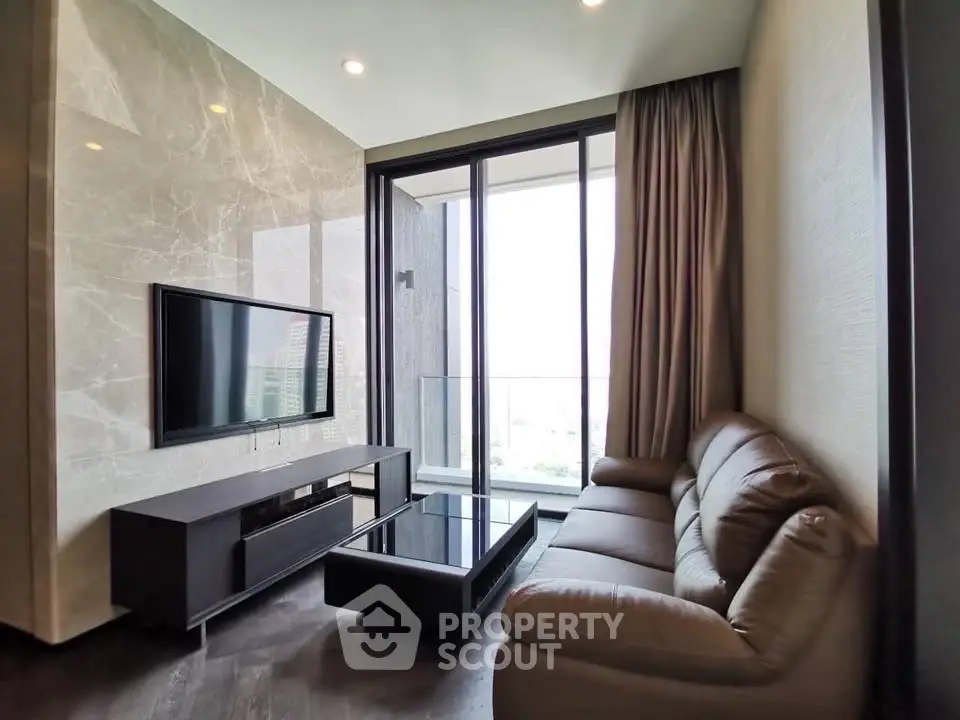 Luxurious living room with modern decor and floor-to-ceiling windows offering stunning views.