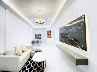 Modern living room with elegant lighting and marble accent wall