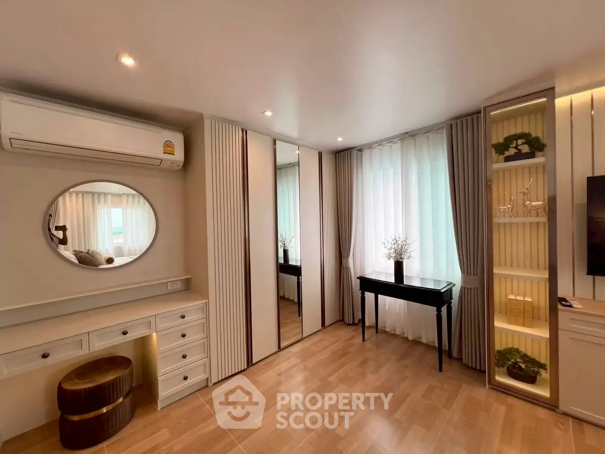 Elegant bedroom with mirrored wardrobe and stylish decor