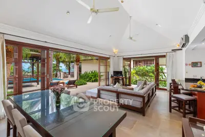 Luxurious open-plan living room with pool view and tropical garden access