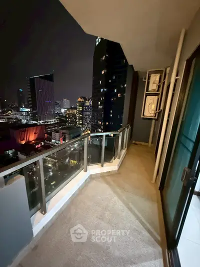 Spacious balcony with stunning city skyline view at night