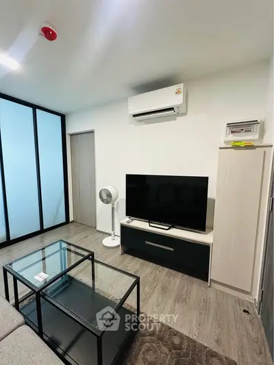 Modern living room with sleek furniture and air conditioning, perfect for comfortable living.
