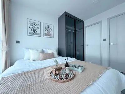 Modern bedroom with stylish decor and cozy ambiance, featuring a comfortable bed and elegant wall art.