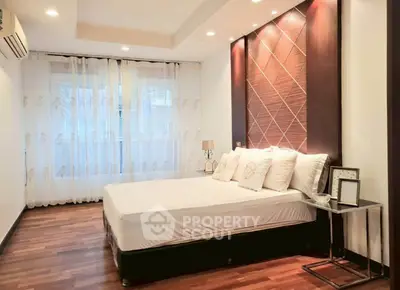 Elegant bedroom with modern decor and wooden flooring