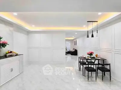 Spacious modern dining area with elegant lighting and marble flooring