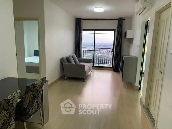 Modern living room with balcony and city view in high-rise apartment