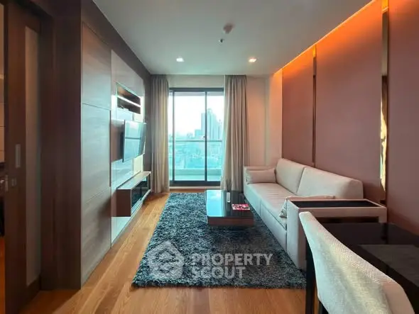 Modern living room with city view, featuring sleek furniture and warm lighting, perfect for urban living.
