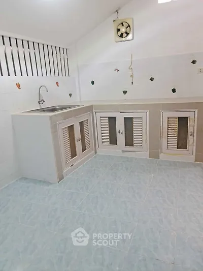 Charming kitchen with closed layout and ample cabinet space, perfect for culinary enthusiasts.