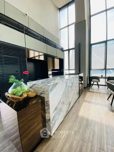 Luxurious modern living room with high ceilings and elegant marble accents.