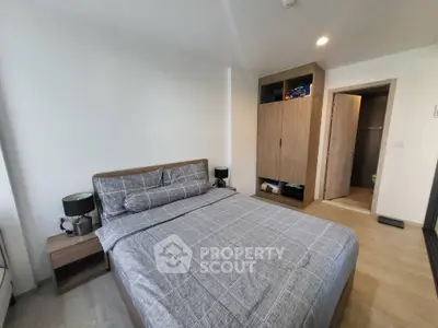 Modern bedroom with stylish decor and ample storage in a contemporary apartment.
