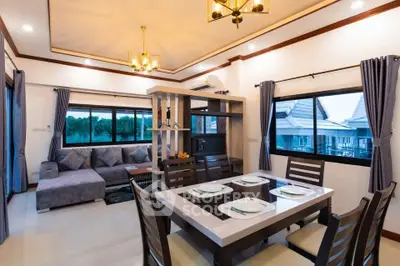 Spacious living and dining area with elegant decor and large windows offering scenic views.