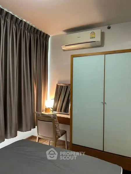 Cozy bedroom with air conditioning and elegant curtains, perfect for relaxation.