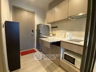 Modern compact kitchen with sleek cabinetry and essential appliances