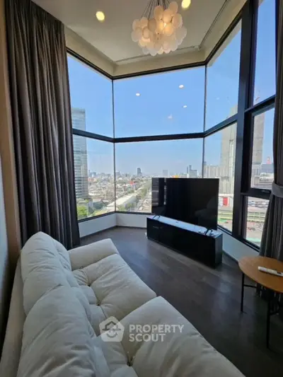 Luxurious corner living room with panoramic city views and modern furnishings.