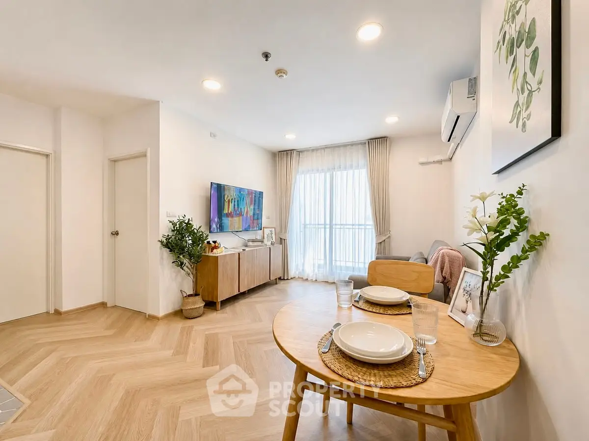 Modern living room with stylish decor and natural light, featuring a cozy dining area and elegant furnishings.