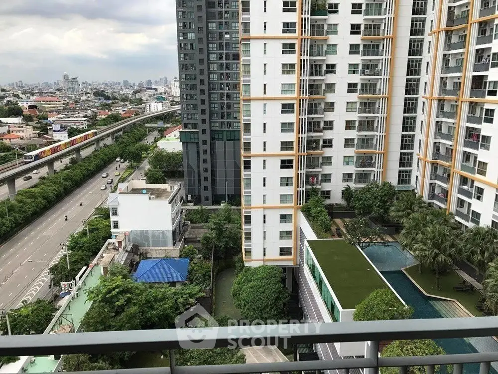 High-rise apartment view with pool and cityscape