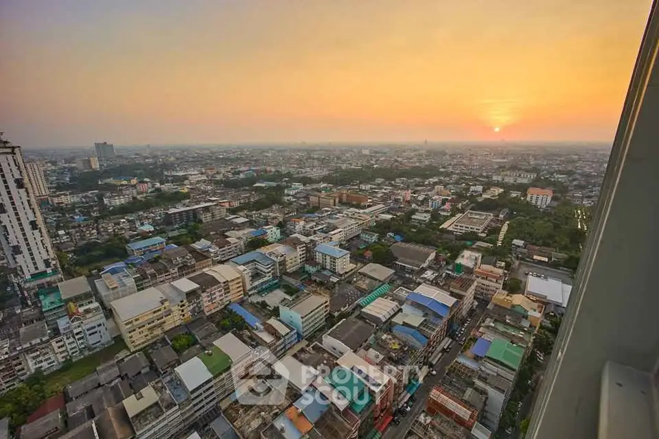 Stunning panoramic city view from high-rise building at sunset, showcasing urban landscape and vibrant skyline.