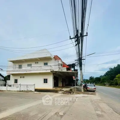 Spacious two-story building with potential for commercial use on a busy street corner.