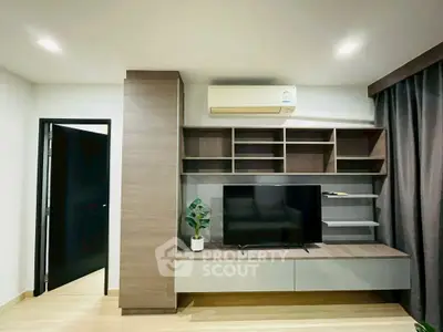 Modern living room with sleek TV unit and air conditioning