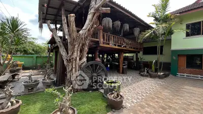 Charming rustic home with unique wooden architecture and lush garden.