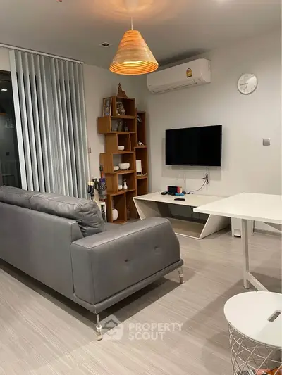 Modern living room with sleek furniture and wall-mounted TV