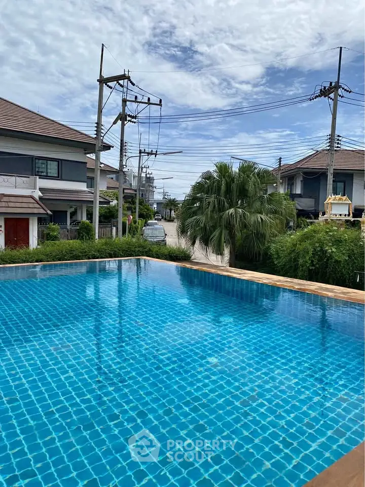 Stunning residential pool with serene neighborhood view, perfect for relaxation and leisure.
