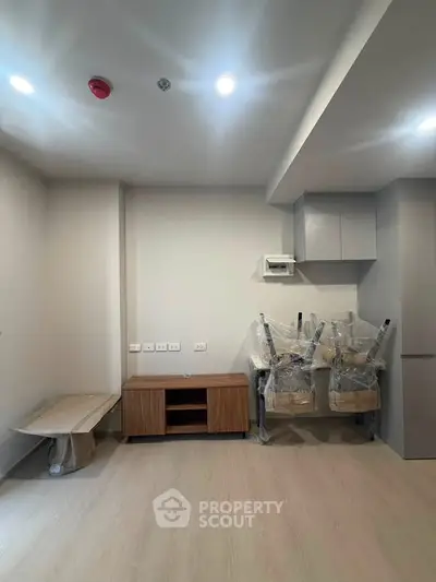 Modern unfurnished living room with light wood flooring and recessed lighting