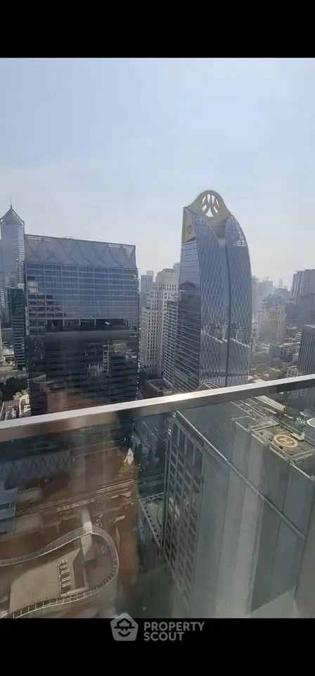 Stunning cityscape view from high-rise balcony with modern skyscrapers.