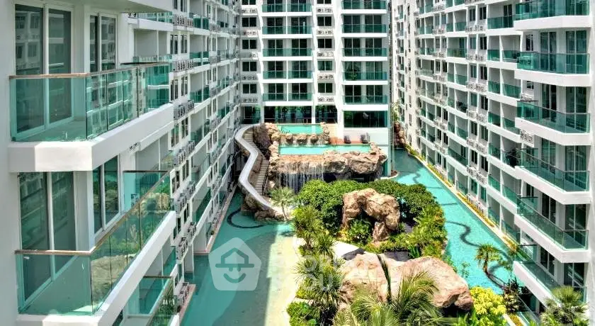 Luxurious condominium with stunning pool and lush landscaping in a modern building complex.