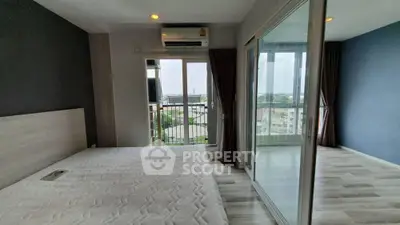 Modern bedroom with balcony view in high-rise apartment