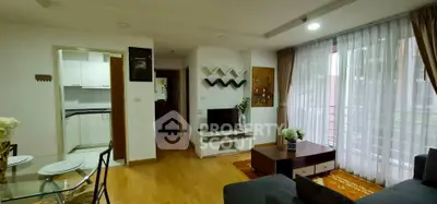 Cozy living room with modern decor and large window in a stylish apartment.