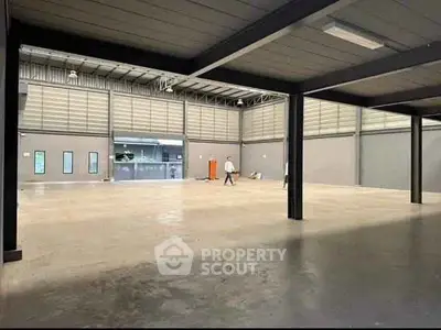 Spacious industrial warehouse with high ceilings and ample floor space.