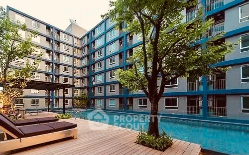Inviting modern apartment complex with a sparkling pool, surrounded by lush greenery and stylish lounging areas, perfect for urban living.