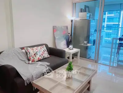 Modern living room with cozy sofa, stylish decor, and bright balcony view in urban apartment.