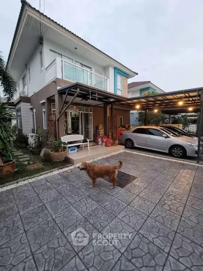 Modern two-story house with spacious driveway and carport, featuring a charming garden and pet-friendly environment.